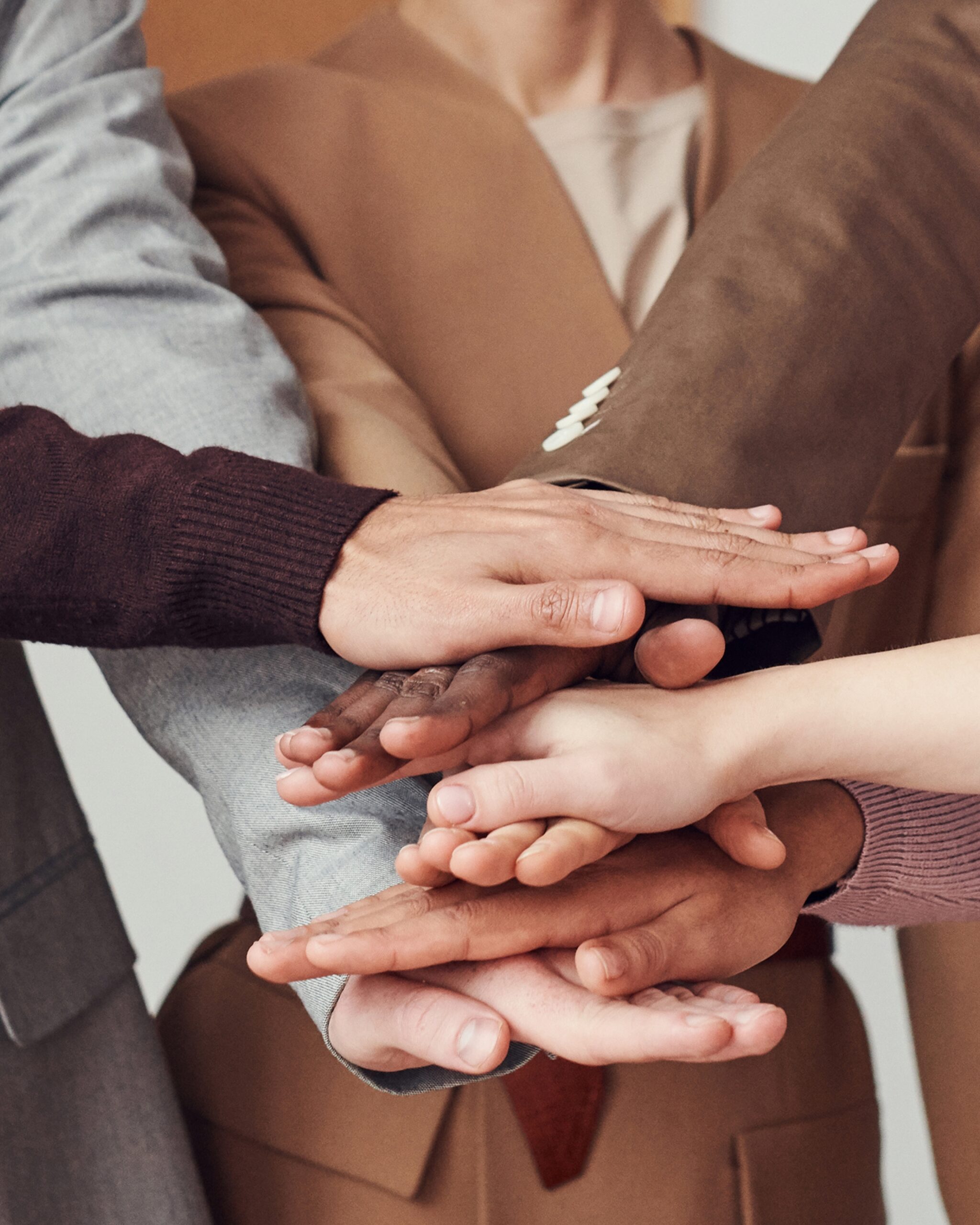 Wasserman Business Law - Group With Hands Together Diverse group with hands together